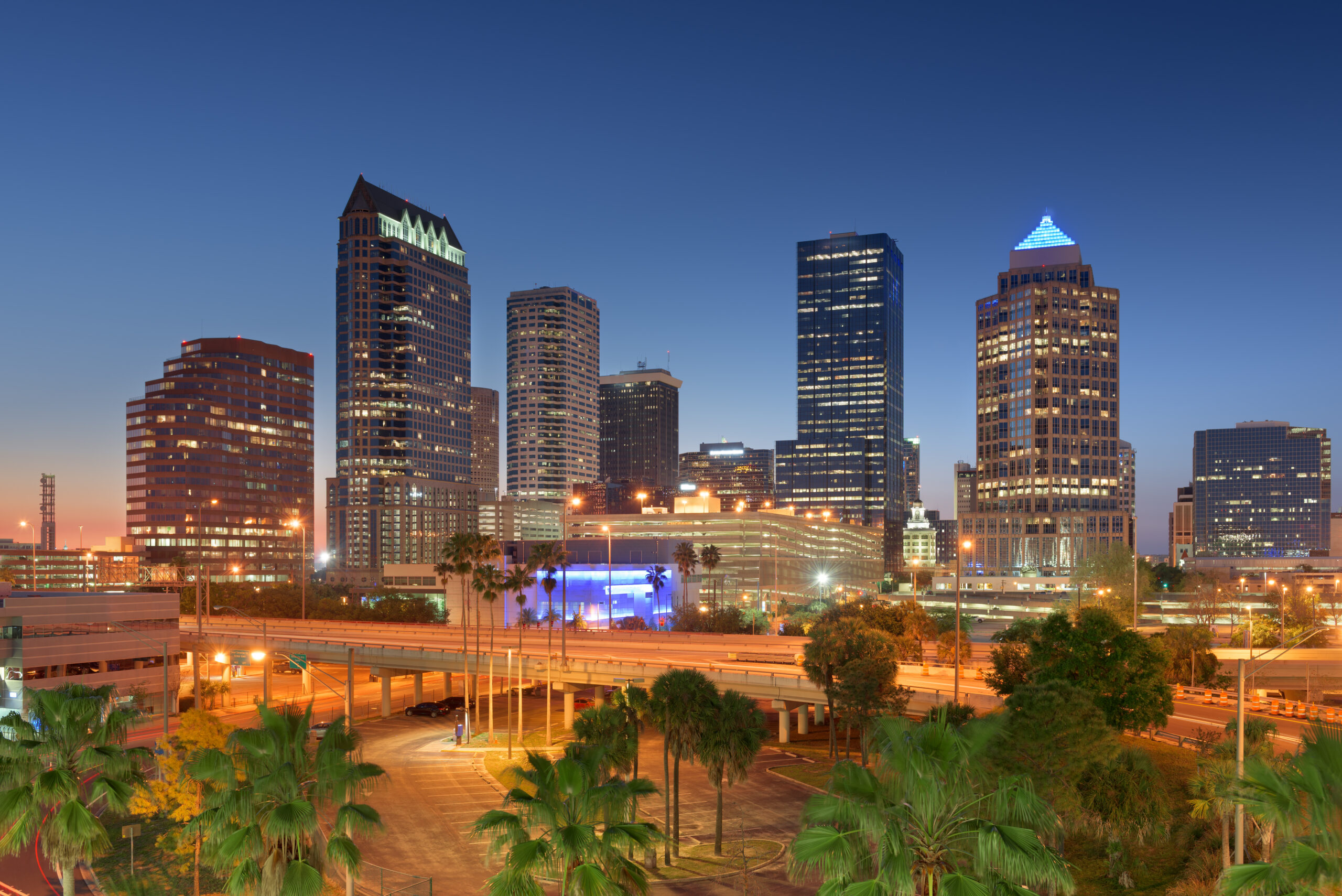 Tampa, Florida, USA downtown city skyline over roads and highways at dusk.